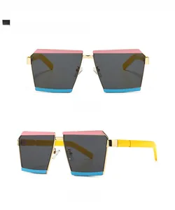 Detail of color block sunglasses with gold metal frame pink blue rims and yellow temples
