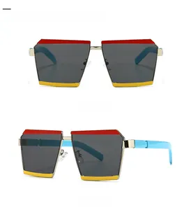 Detail view showing oversized geometric sunglasses with multi-color frame and grey lenses