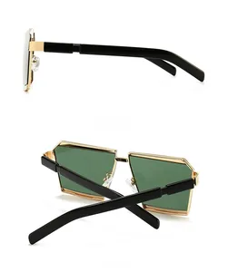 Detail of geometric sunglasses showing gold bridge and black side temple arms