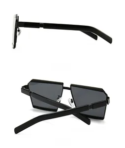 Detail view of black geometric oversized sunglasses showing side profile and back folding