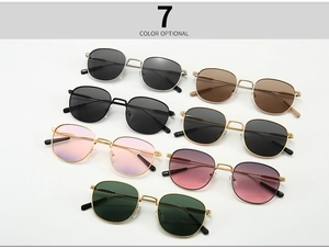 Flat lay of retro round metal sunglasses in seven different color gradients and frame finishes