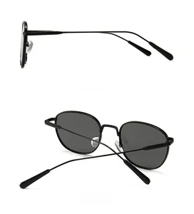 Detail views showing the slim metal temples and dark round lenses of black sunglasses