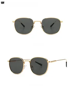 Detail view of vintage round sunglasses with gold metal frame and dark grey lenses