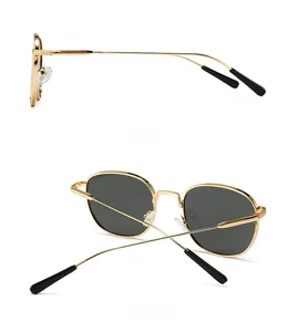 Detail view showing the sleek gold metal frame and side profile of round sunglasses