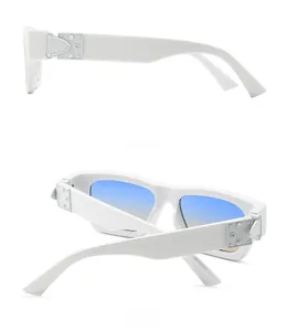 Detail of white acetate frame sunglasses featuring rivet hinges and gradient lenses