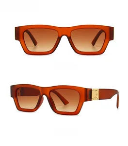 Detail view of amber retro oversized sunglasses with brown gradient lenses and gold metal accents