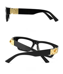 Side and back view of retro oversized black sunglasses with gold metal hinge detail