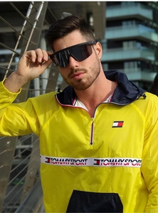Close-up of polarized sports sunglasses worn with a yellow Tommy Sport windbreaker jacket