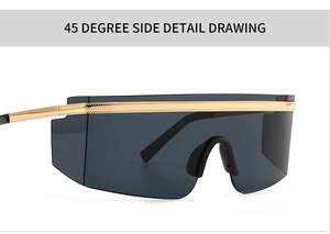 Detail view of modern oversized shield sunglasses with black lenses and gold metal trim