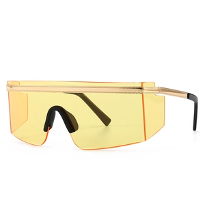 Modern oversized shield sunglasses with gold metal top bar and yellow gradient lenses