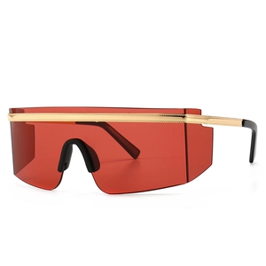 Modern oversized shield sunglasses with red lenses and gold metal trim on black frames