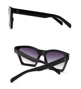 Detail view of retro square sunglasses with triple gold rivets and gradient purple lenses