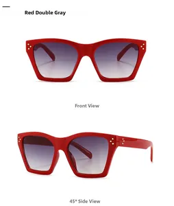Detail of red square sunglasses with triple gold rivets and gradient gray lenses