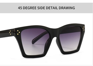 Close-up of black thick frame sunglasses with purple gradient lenses and metal dots