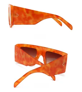 Detail view of orange tortoiseshell flat top sunglasses with side and back profiles