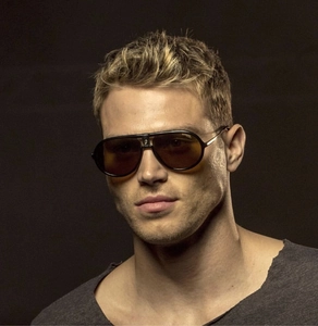 Classic black aviator sunglasses with metal frame and brand logo detail on male model