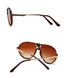 Detail view of tortoiseshell aviator sunglasses with gold temples and gradient lenses
