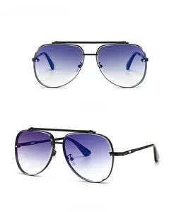 Detail view of retro oversized pilot sunglasses with blue gradient lenses and black metal frame