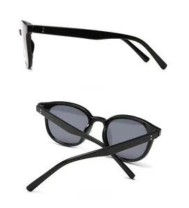 Side and back view of retro black chunky sunglasses with grey lenses and rivet details