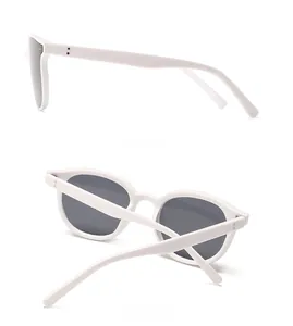 Side and back view of white frame sunglasses with rivet details and dark grey lenses