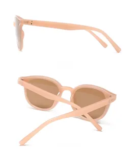 Side and back view of peach pink cat-eye sunglasses with silver rivet accents