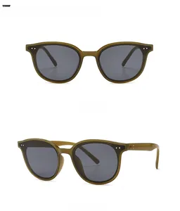 Green oversized sunglasses with black gray lenses and silver rivet studs from two angles