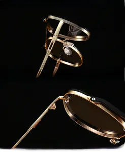 Macro view of gold metal frame sunglasses with thick UV protection lenses and hinges