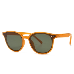 Classic retro sunglasses with amber transparent frame, green lenses, and rivet accents