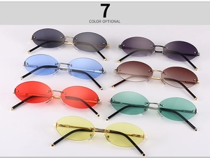 Flat lay display of oval rimless sunglasses in seven vibrant colors with metal temples