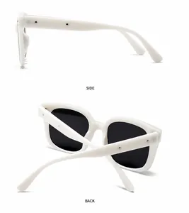 Detail view of retro square white sunglasses with silver metal rivets and grey lenses