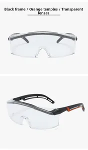 Detail of protective safety goggles featuring black orange frames and clear transparent lenses