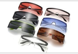 Detailed flat lay of oversized flat top shield sunglasses in seven trendy vibrant colors