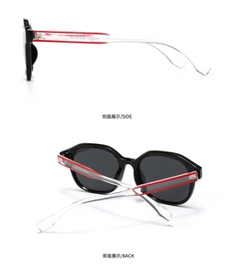 Detailansicht der modernen schwarzen Sonnenbrille mit transparenten Bügeln und rotem Kern