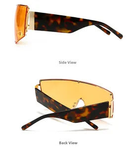 Vue détaillée de lunettes de soleil oversize avec verres orange et branches en écaille