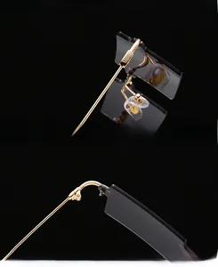 Macro view of rimless square sunglasses detailing golden metal hinges and gray UV lenses
