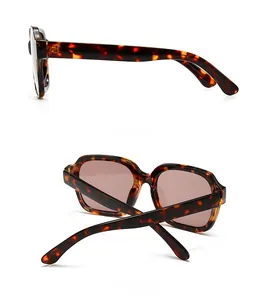 Detail view showing tortoiseshell frame and tinted lenses of these square sunglasses