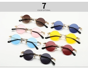 Close-up of seven vintage rimless sunglasses in various colors with metallic gold frames