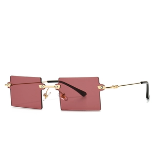 Modern rectangular rimless sunglasses with burgundy lenses and gold metal frame