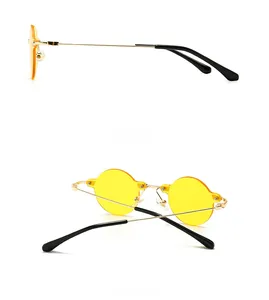 Detail view of vintage square sunglasses featuring yellow lenses and slim metal temples