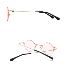 Side and back view of retro rimless sunglasses with pink lenses and gold metal temples