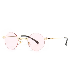 Modern retro pink round rimless sunglasses with gold metal frame for a stylish street look