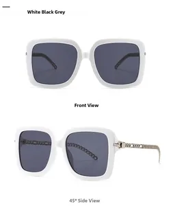 Detail of square oversized sunglasses with white frames and metal chain temples