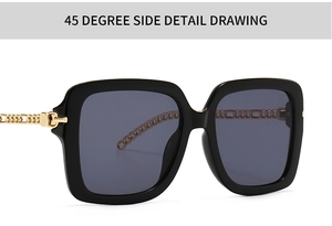 Detail view of square black sunglasses with decorative gold chain metal temples