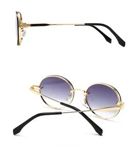 Detailansicht der ovalen Sonnenbrille mit goldenem Metallrahmen und lila Verlauf