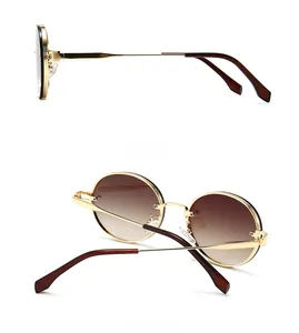 Detaillierte Seiten- und Rückansicht der ovalen Gold-Sonnenbrille mit Verlaufsgläsern