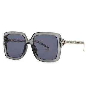 Square oversized sunglasses with transparent gray frames and metal chain temples