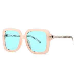 Square pink sunglasses with light blue lenses and silver chain temple design