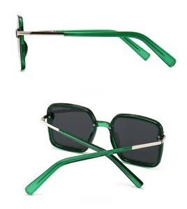 Detail view of square green sunglasses showing side frame and back folding angle
