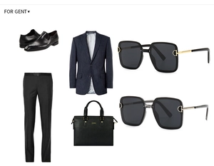 Flat lay of men's navy pinstripe suit, leather derby shoes, briefcase, and square sunglasses