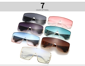 Detail view of oversized rimless sunglasses in seven gradient colors with metal temples